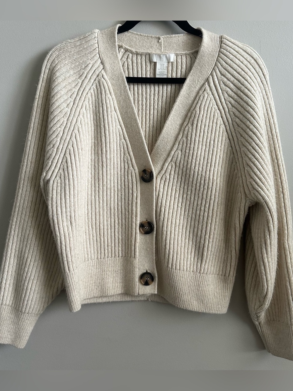 Cream ribbed knit cardigan from H&M featuring large tortoiseshell buttons.